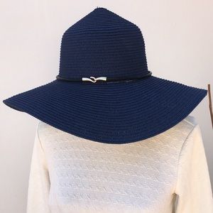 Blue summer hat with gold and black accessory